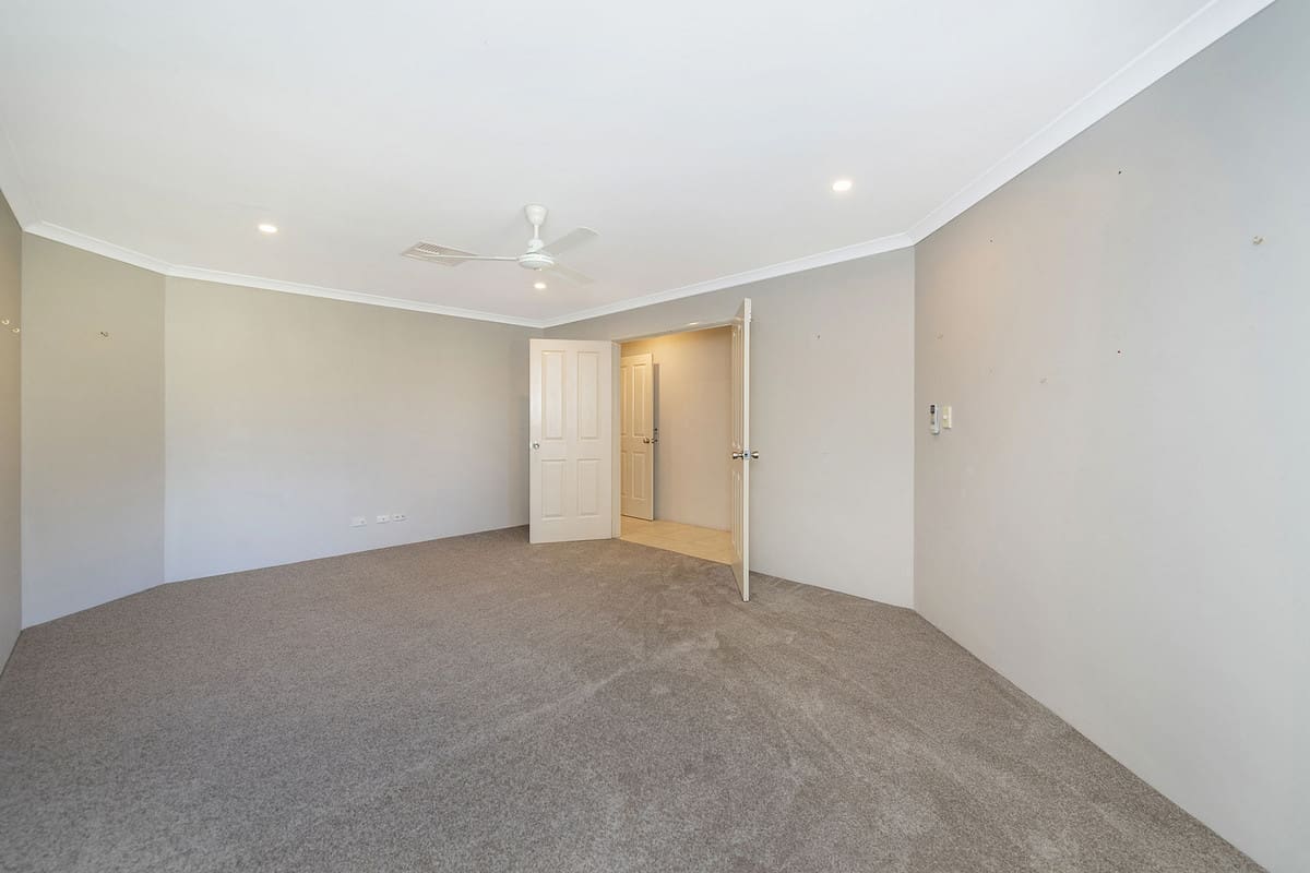 Spacious, empty room with carpet.