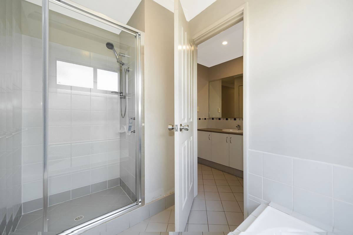Modern bathroom with shower and vanity.