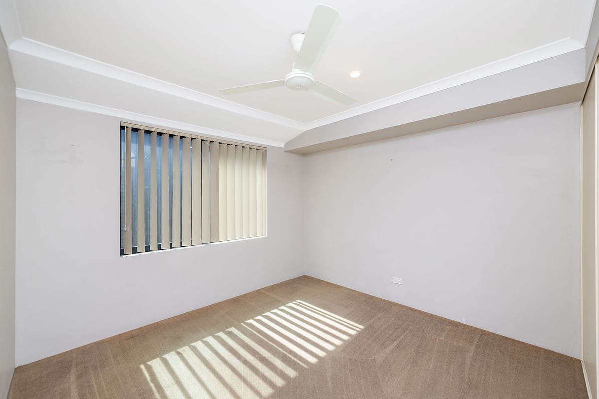 Empty room with vertical blinds.
